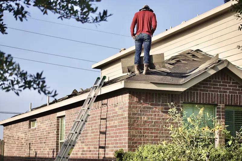 Professional roofer working on a residential roof in North Oaks Manor